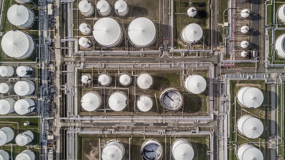 Aerial view white fuel storage tank in oil refinery plant, Top view white Industrial tanks for petrol and oil.